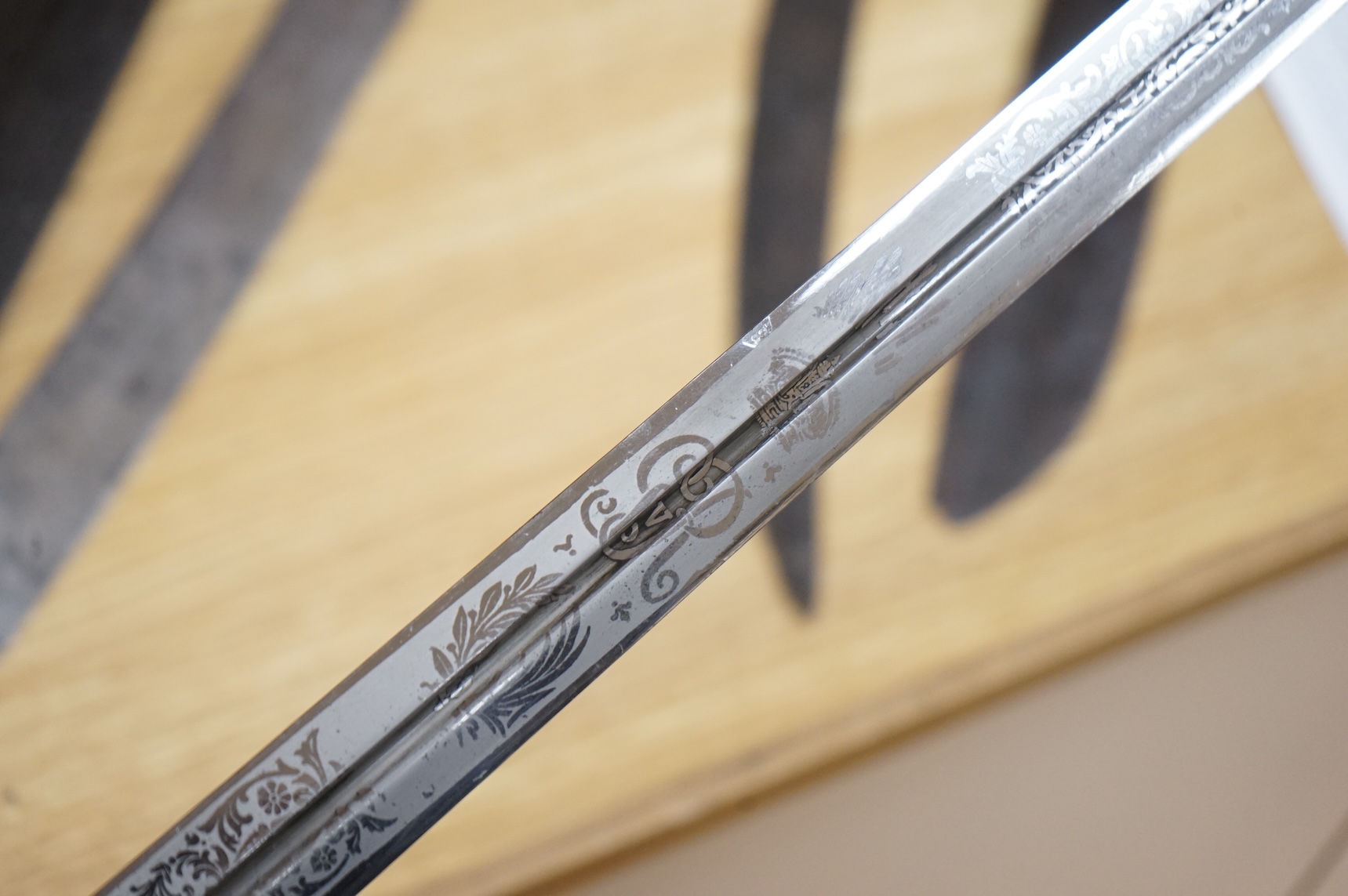 World War I Scottish infantry officer’s undress sword, etched and polished regulation blade with crowned GVR cipher and regulation cruciform hilt, in its leather scabbard